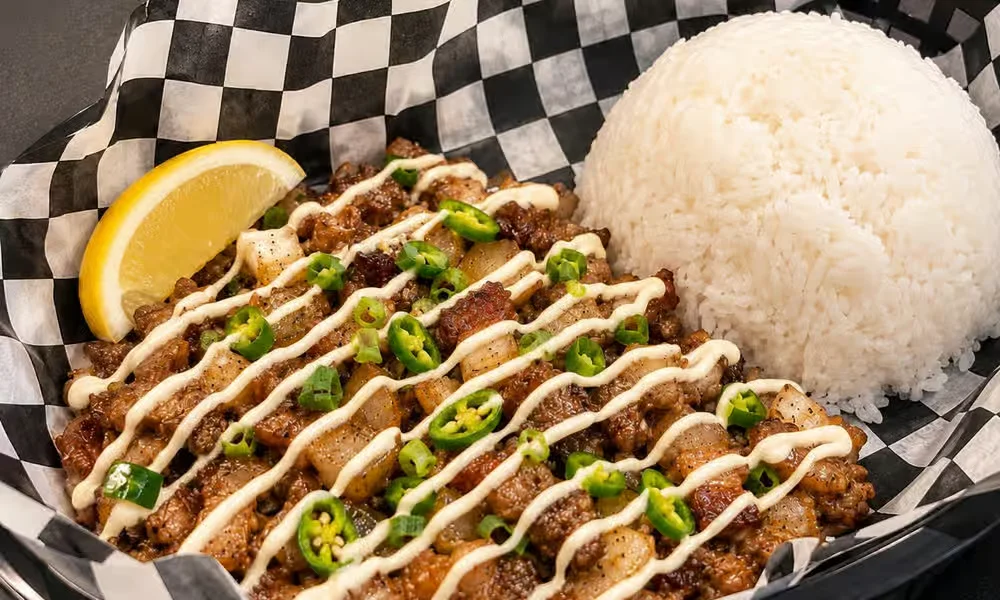 Crispy sisig combo with chopped pork, green chilli, creamy sauce and rice at Kalan At Night, Winnipeg