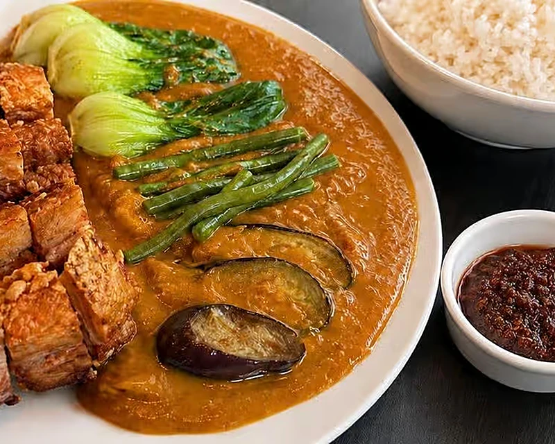 Lechon kare-kare Filipino peanut stew with pork belly, vegetables and bagoong at Kalan Restaurant, Winnipeg
