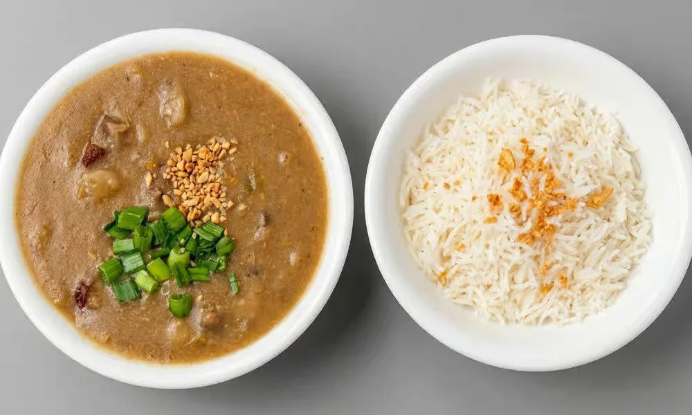 Pares Filipino braised beef stew with peanuts and spring onion served with a bowl of rice at Kalan At Night, Winnipeg