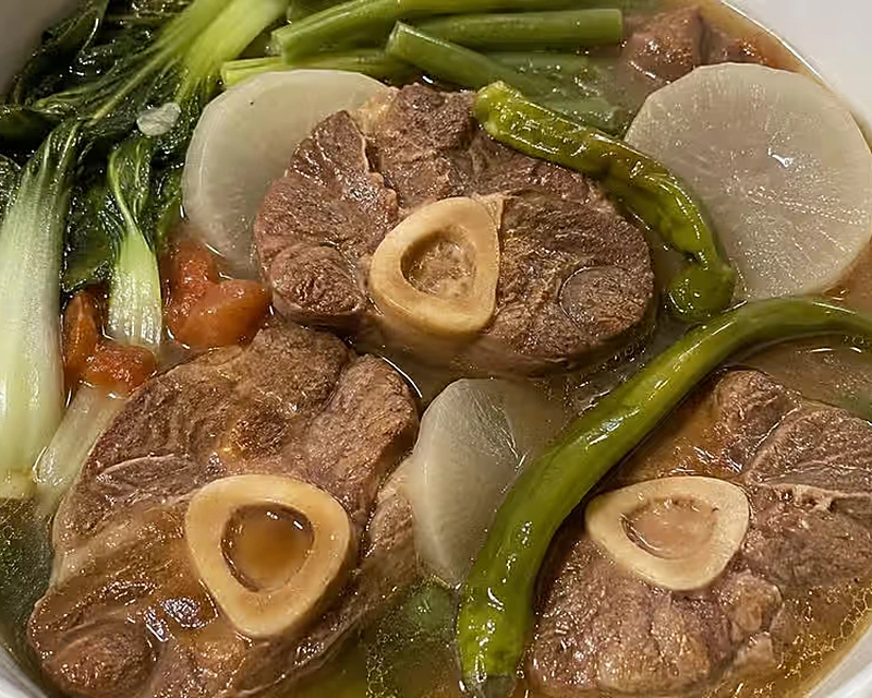 Sinigang na bulalo Filipino sour beef shank soup with vegetables at Kalan Restaurant, Winnipeg